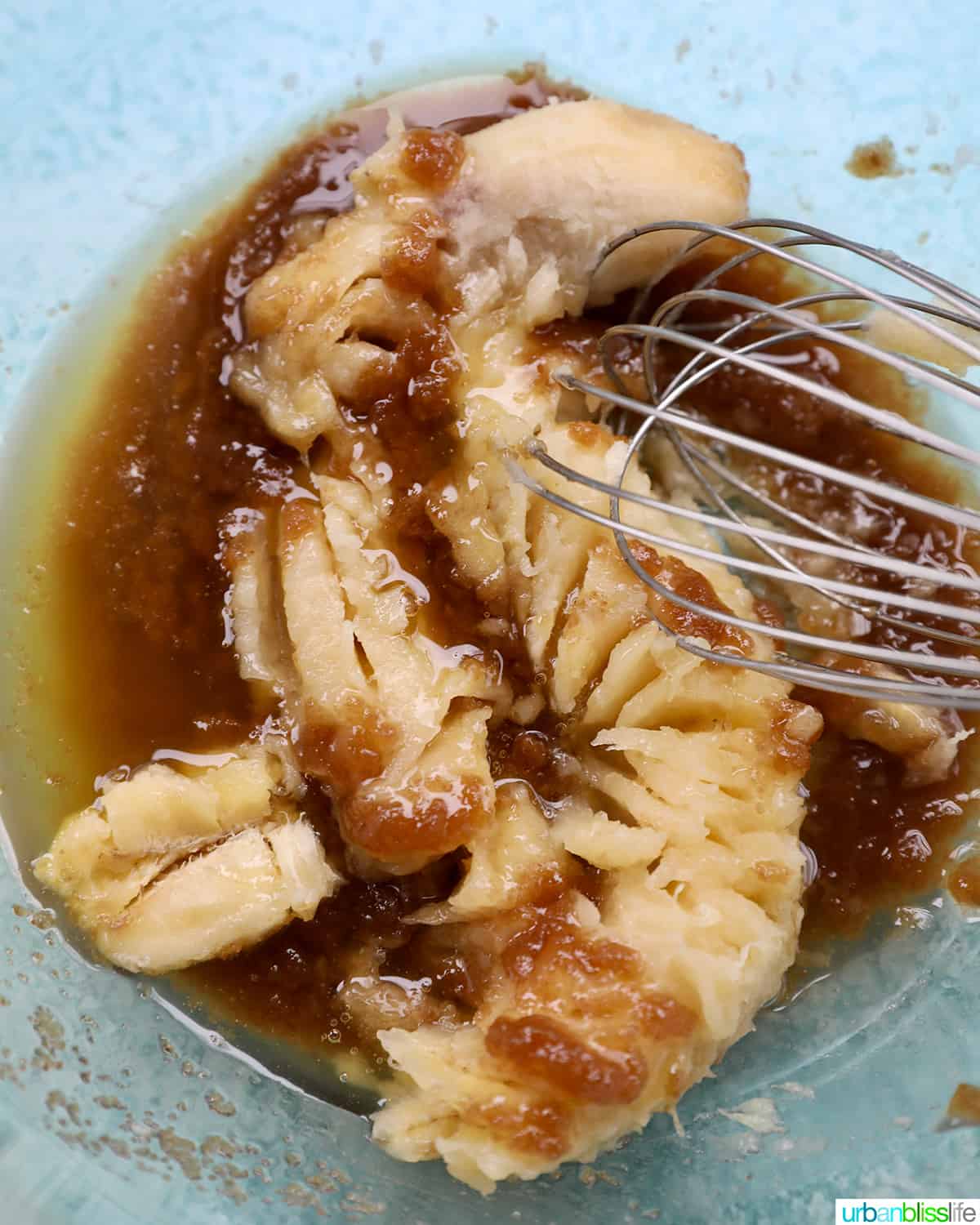 mashing banana into mixture for cookies