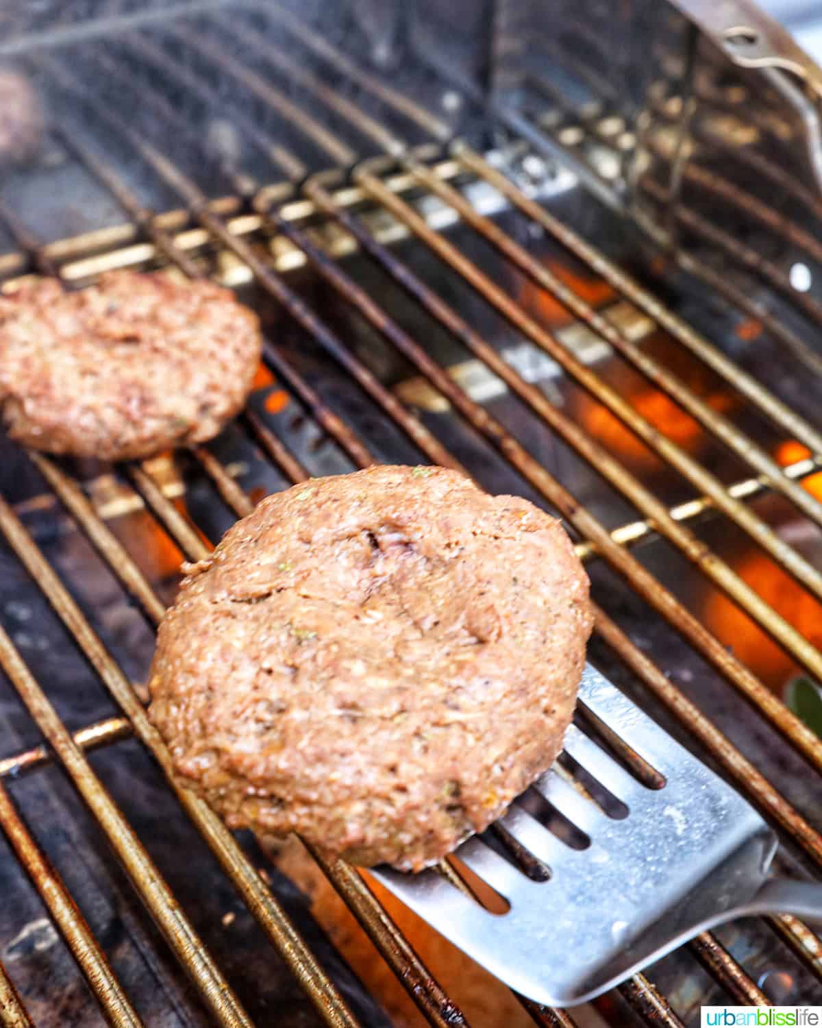 flipping hamburgers on a grill