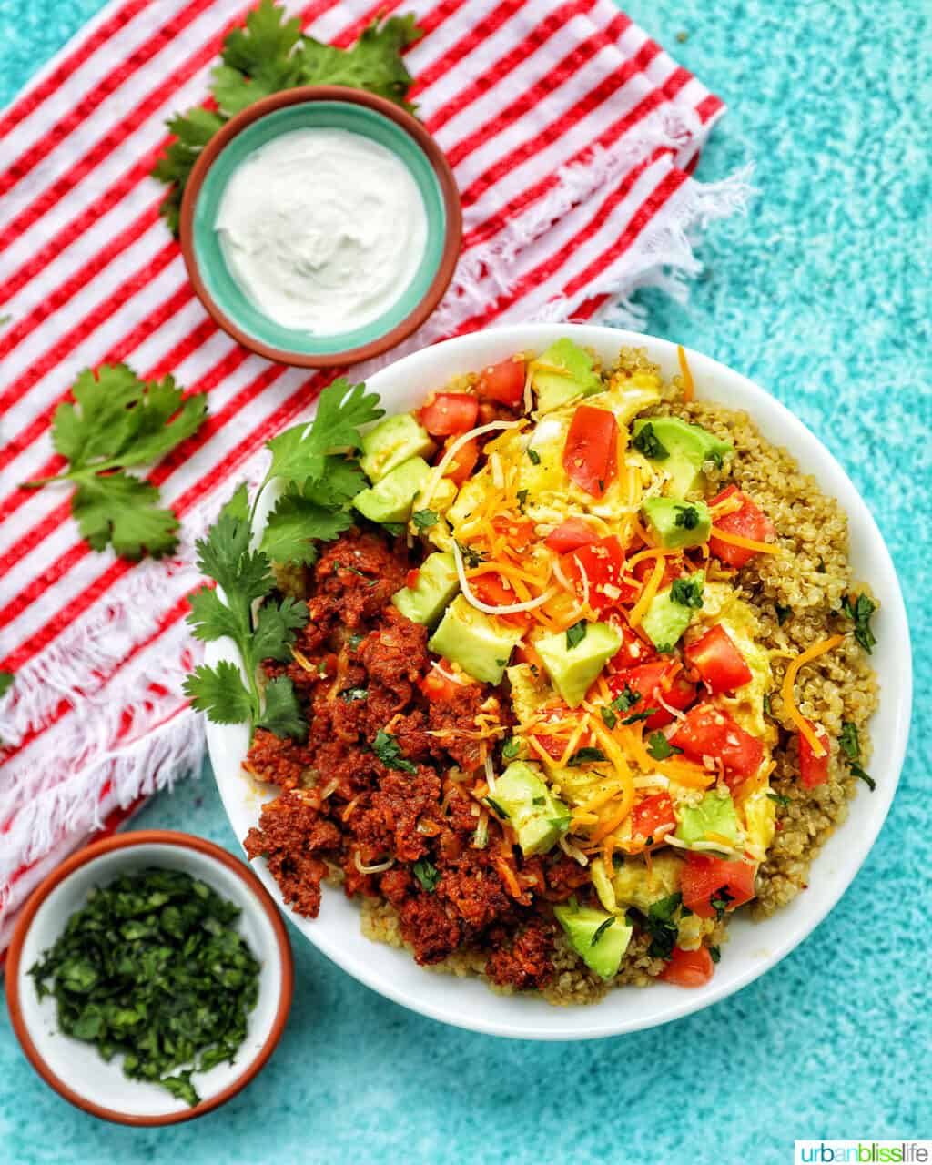 chirozo breakfast bowl with sides of sour cream and cilantro