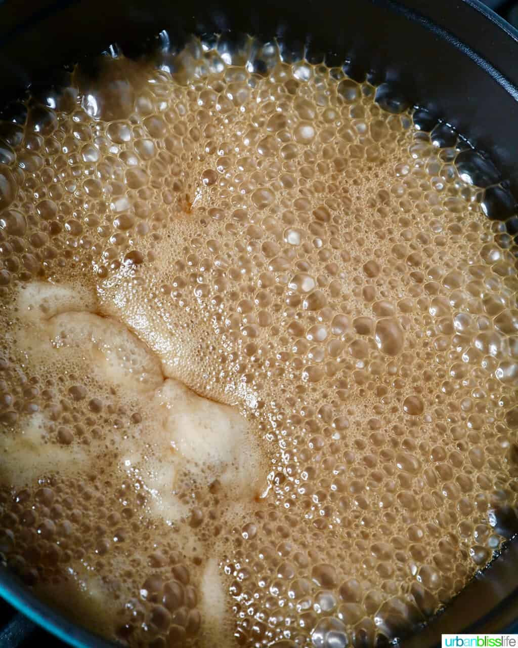 coconut milk and brown sugar boiling for filipino biko