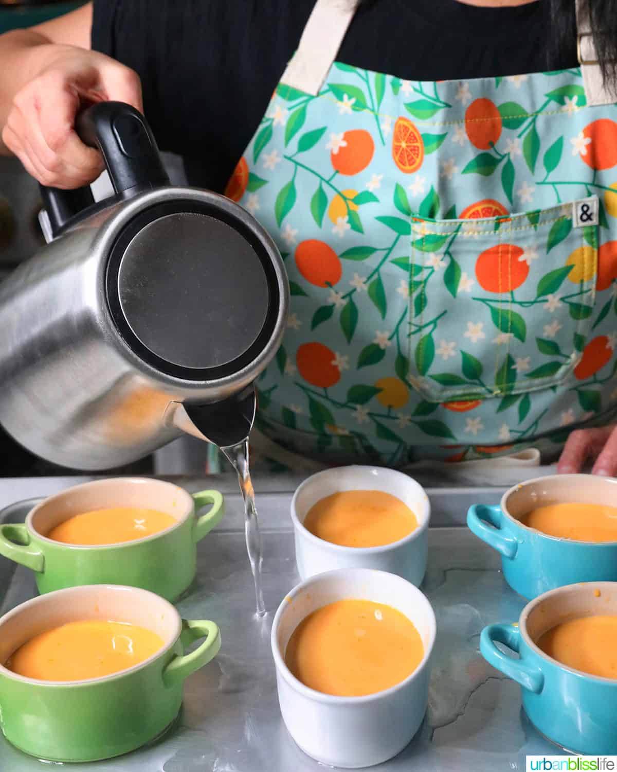 pouring water into baking sheet for leche flan