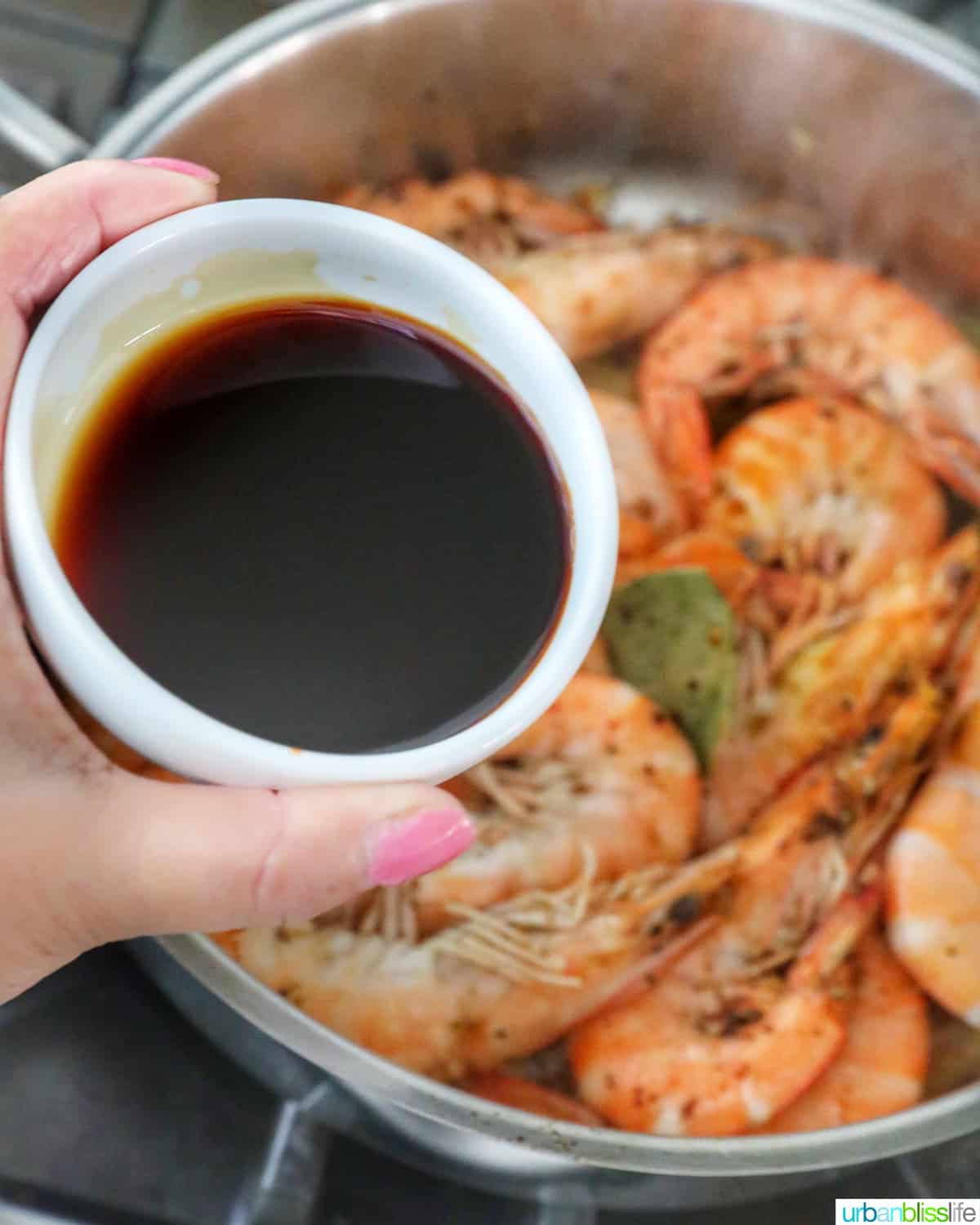 adding soy sauce to shrimp adobo