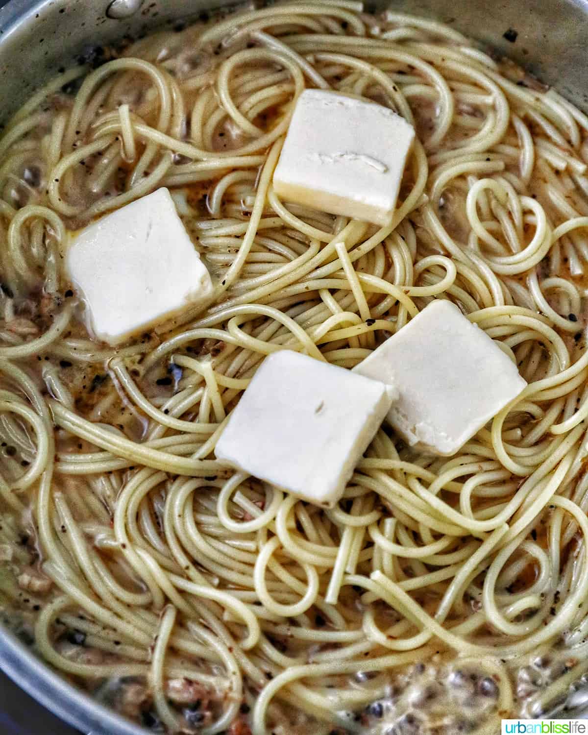 adding butter to pasta