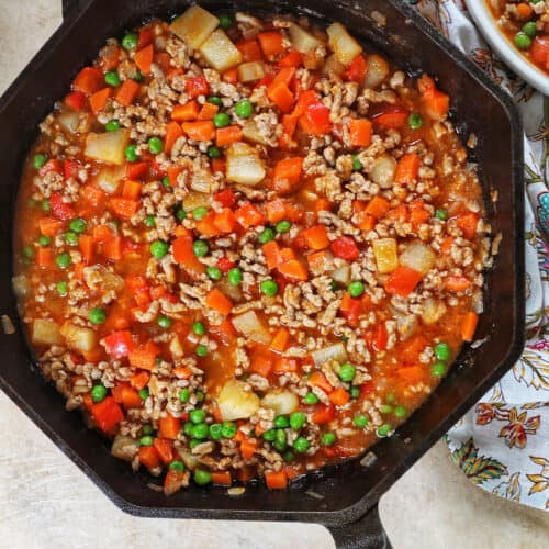 ground pork menudo in a cast iron skillet
