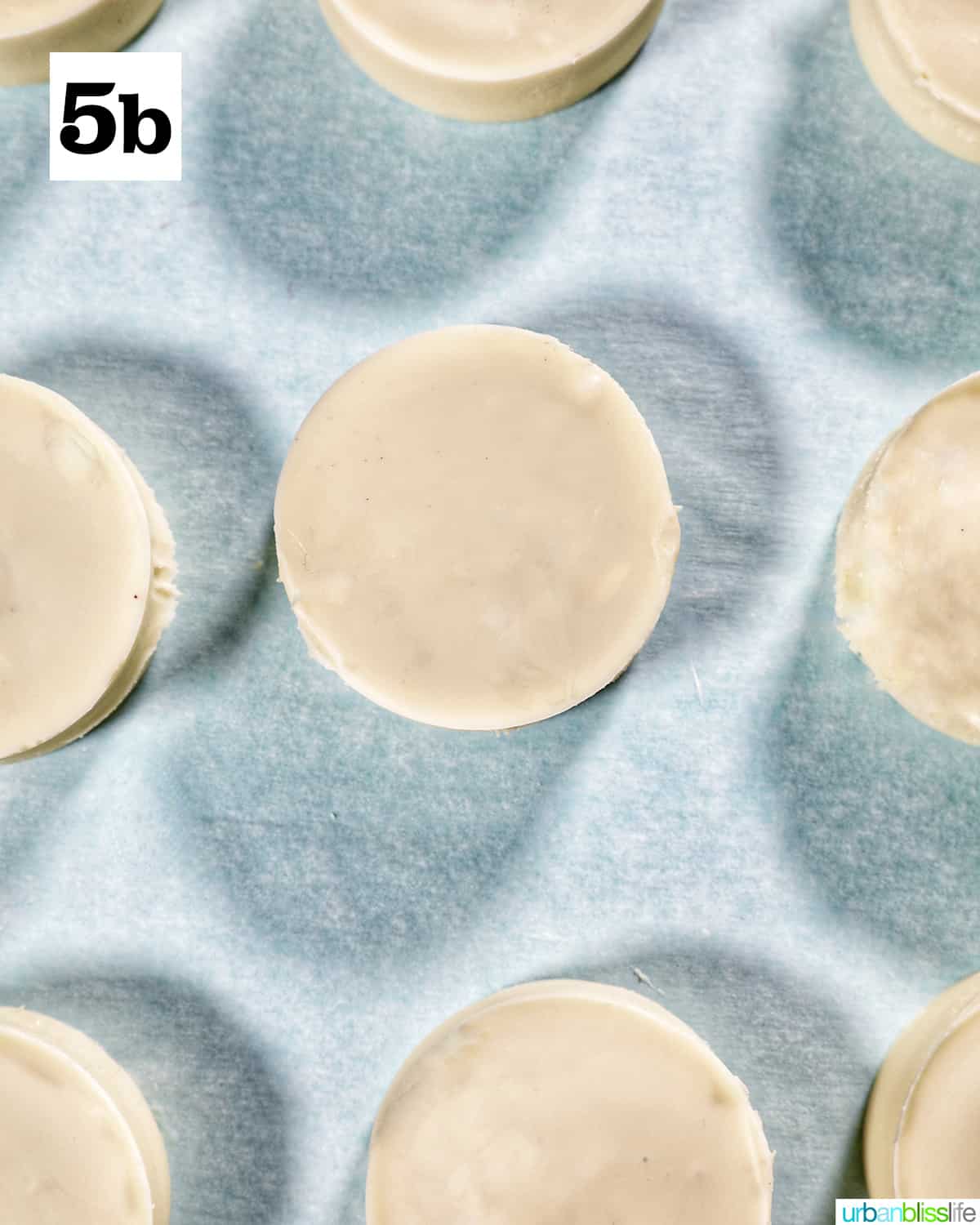 white chocolate covered Oreo cookies on parchment paper.