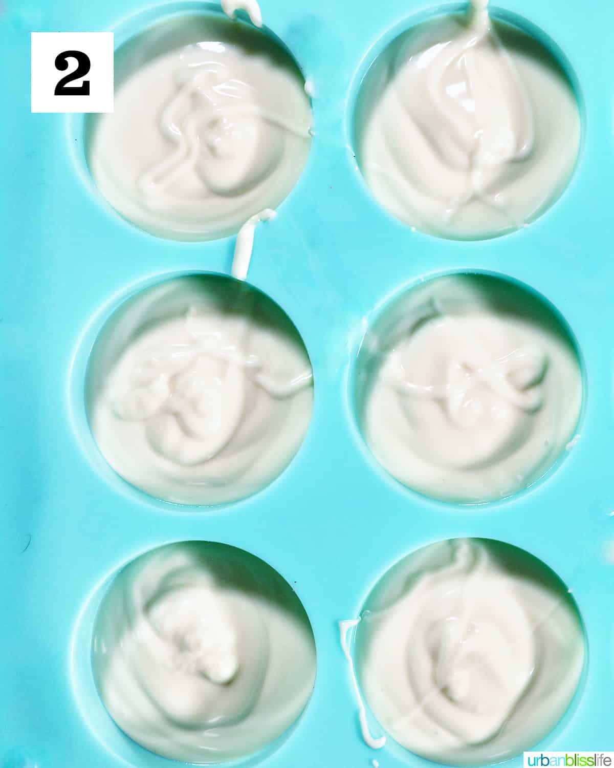 white chocolate poured into blue chocolate candy mold.