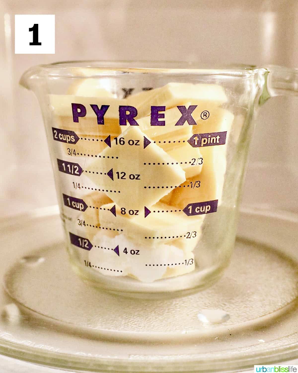 white chocolate pieces in a Pyrex glass measuring cup in the microwave.