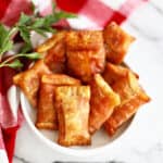 air fryer pizza rolls in a white bowl.