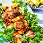 grilled bacon wrapped scallops on bed of lettuce.
