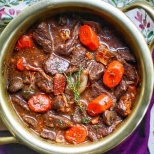 classic beef bourguignon in a gold colored bowl.