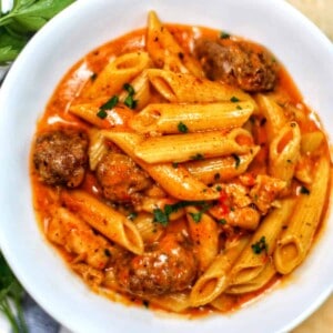 cajun chicken pasta with red sauce in a bowl.