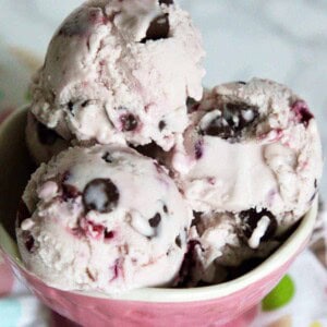 vegan cherry chocolate chip ice cream in a pink serving dish.