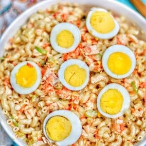 filipino macaroni salad with hard boiled egg halves in bowl.