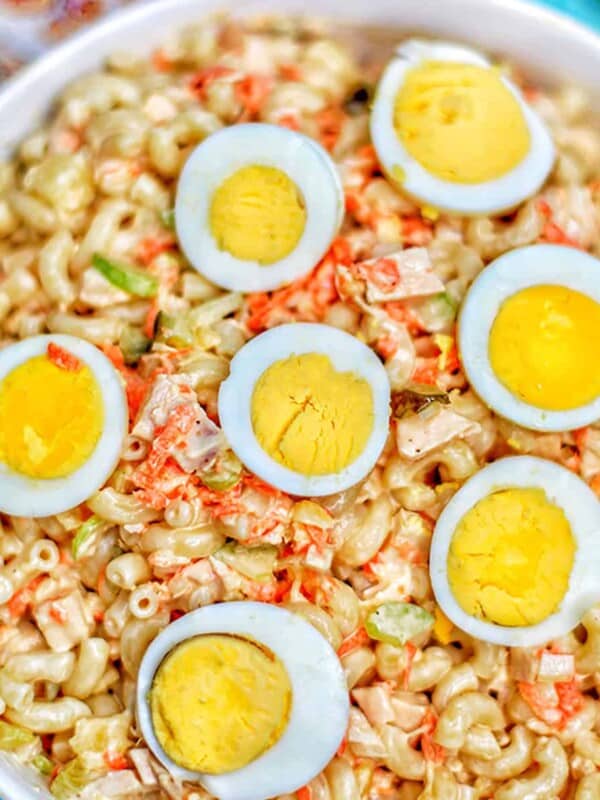 filipino macaroni salad with hard boiled egg halves in bowl.