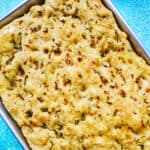 garlic rosemary focaccia bread in a baking pan.