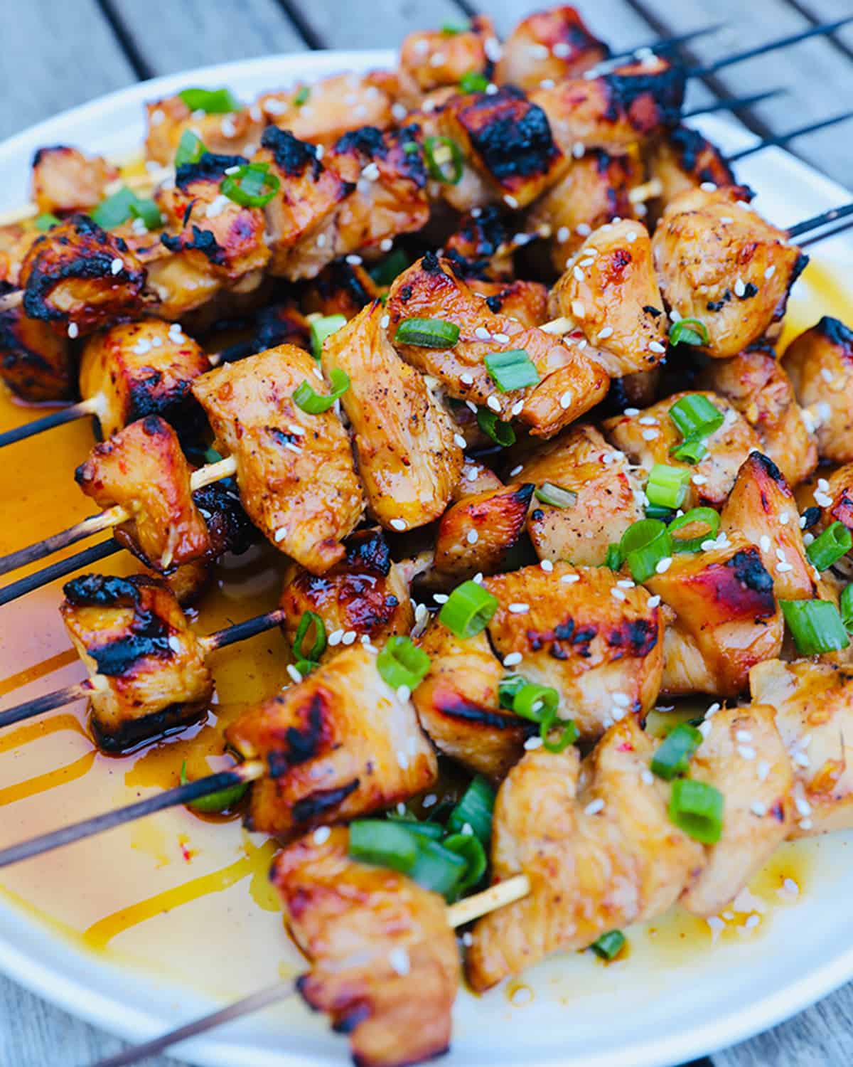 grilled honey garlic chicken skewers on a platter.