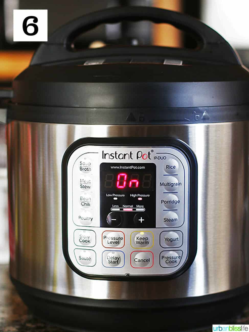 Instant pot electric pressure cooker with ON display.
