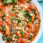 african peanut stew in a white bowl.