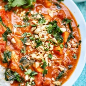 african peanut stew in a white bowl.