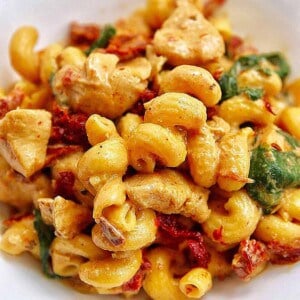 tuscan chicken pasta in a white bowl.