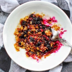 blueberry crisp on white plate.