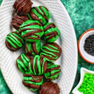 mint oreo truffles on a white platter.