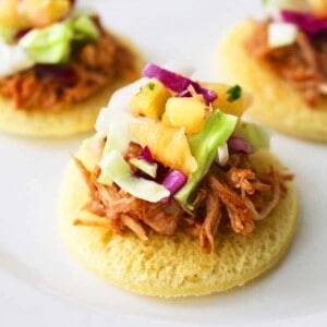 three pineapple pulled pork sliders and slaw.