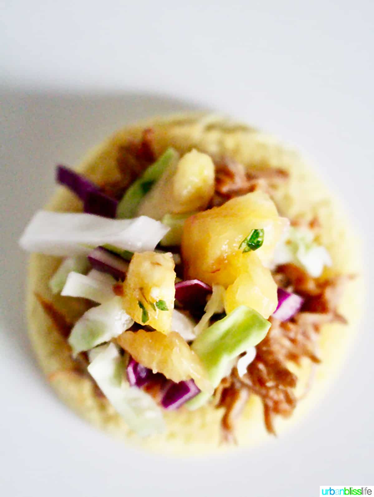single pulled pork sliders topped with pineapple slaw.