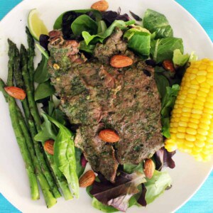 grilled steak with cilantro almond pesto and corn.