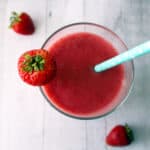 strawberry smoothie with a blue straw.