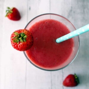 strawberry smoothie with a blue straw.