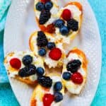 crostini with raspberries, blueberries, and ricotta.