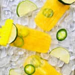 tropical margarita popsicles with jajapeno pepper slices over ice.