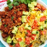 chorizo breakfast bowl with avocado, tomatoes, and cheese.