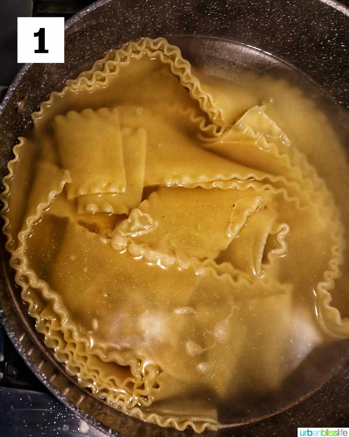 lasagna noodles cooked in a large pot of water covering the noodles.