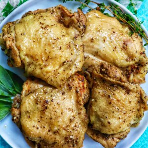 four instant pot chicken thighs on a white plate .