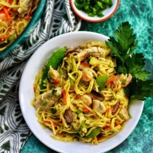 filipino pancit canton in a bowl with parsley.
