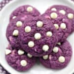white chocolate chip ube cookies on a plate.