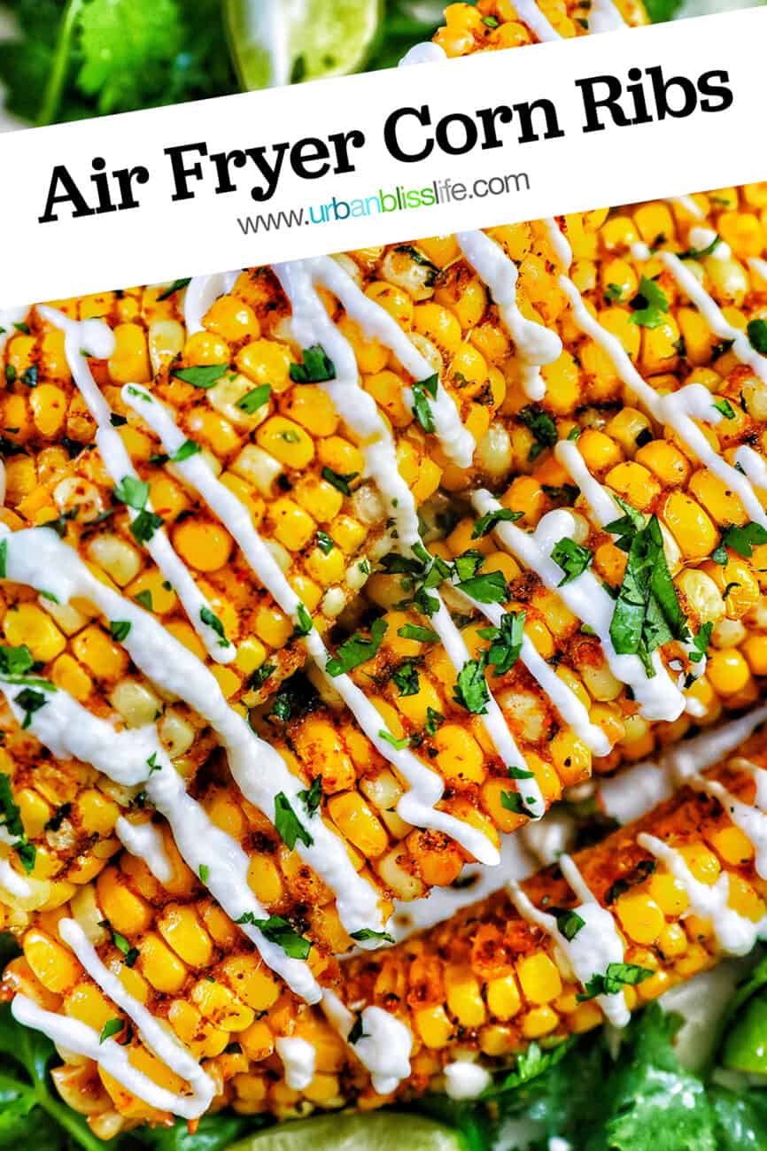 several air fryer corn ribs stacked on top of a bed of greens with drizzled mayo and chopped cilantro with title text overlay.