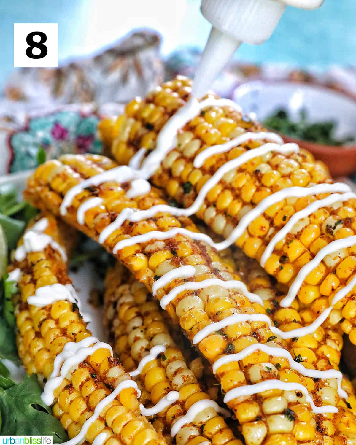 stack of air fryer corn ribs at an angle with drizzled mayo.
