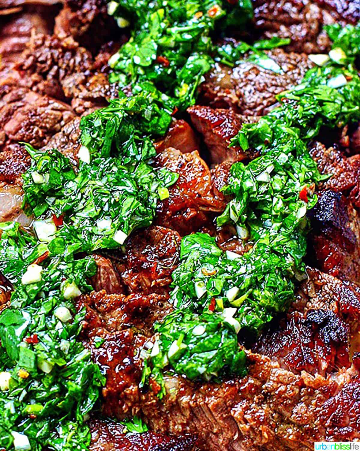 Cast iron rib eye steak with chimichurri sauce.