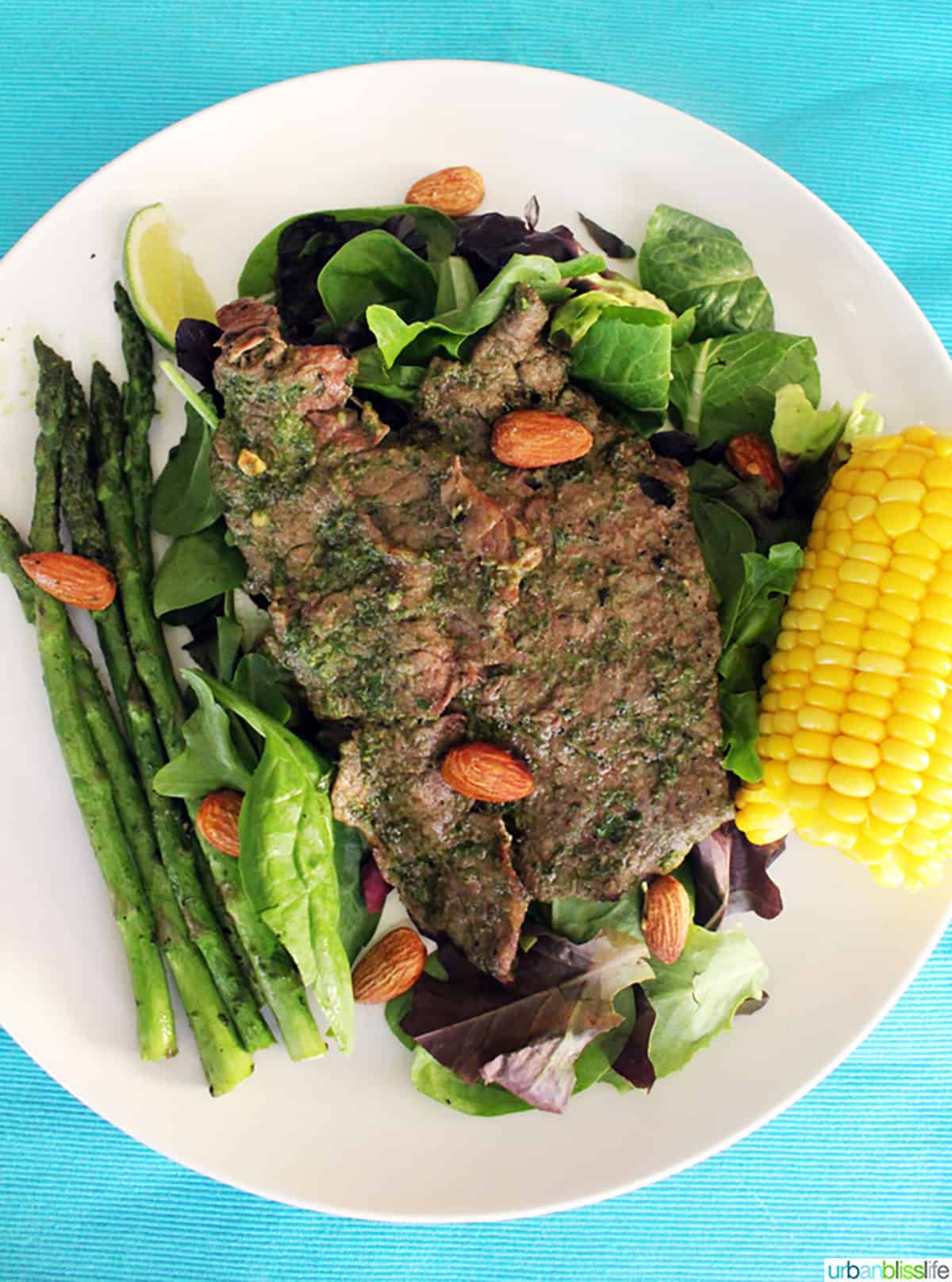 Pesto steak with almonds, asparagus and corn.