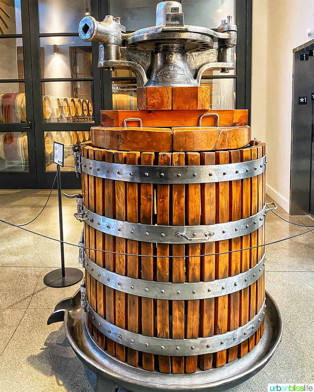 large antique basket wine press in front of the barrel room at Valdemar Estate, a winery in Walla Walla.