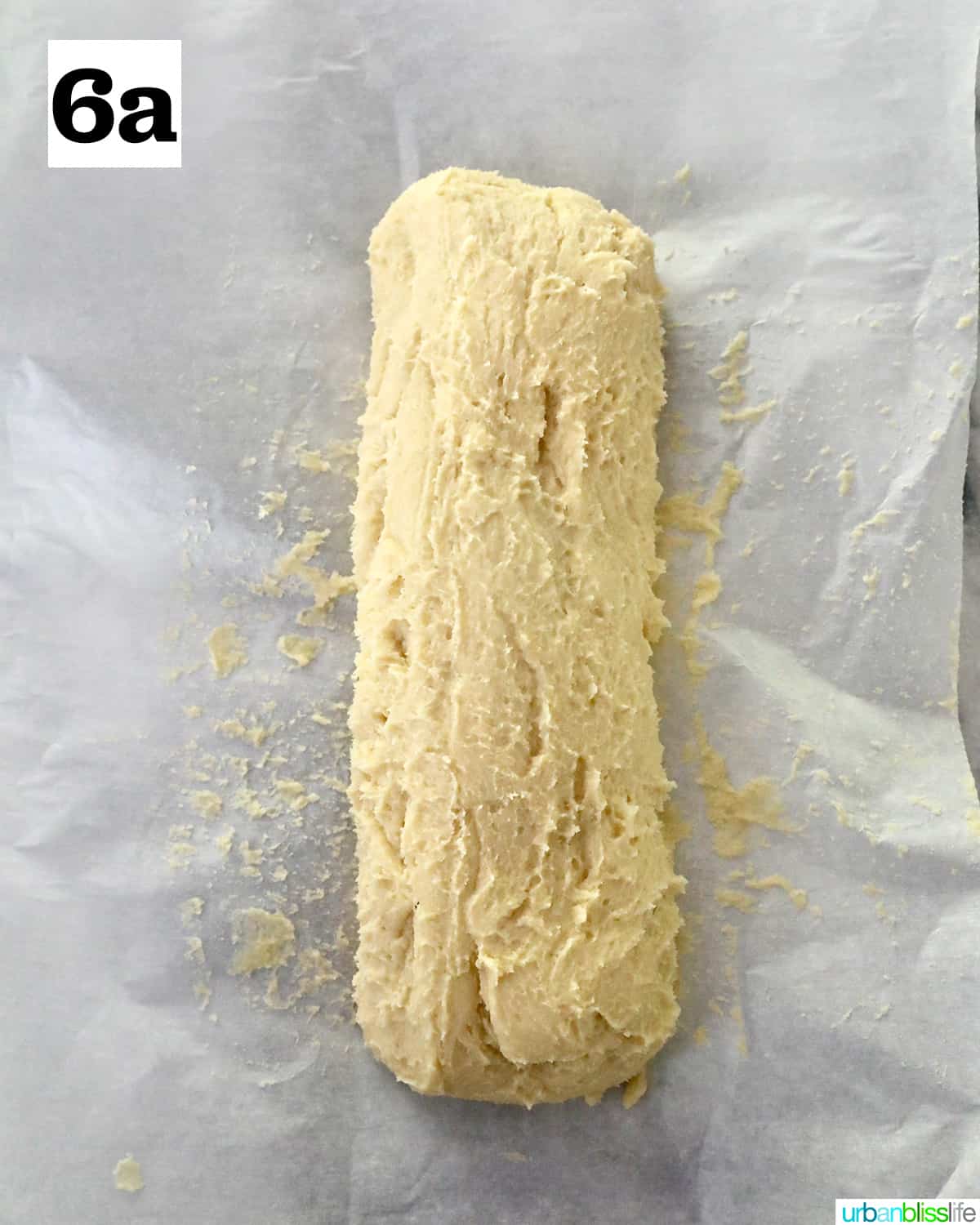 key lime cookie batter shaped into a log on parchment paper.