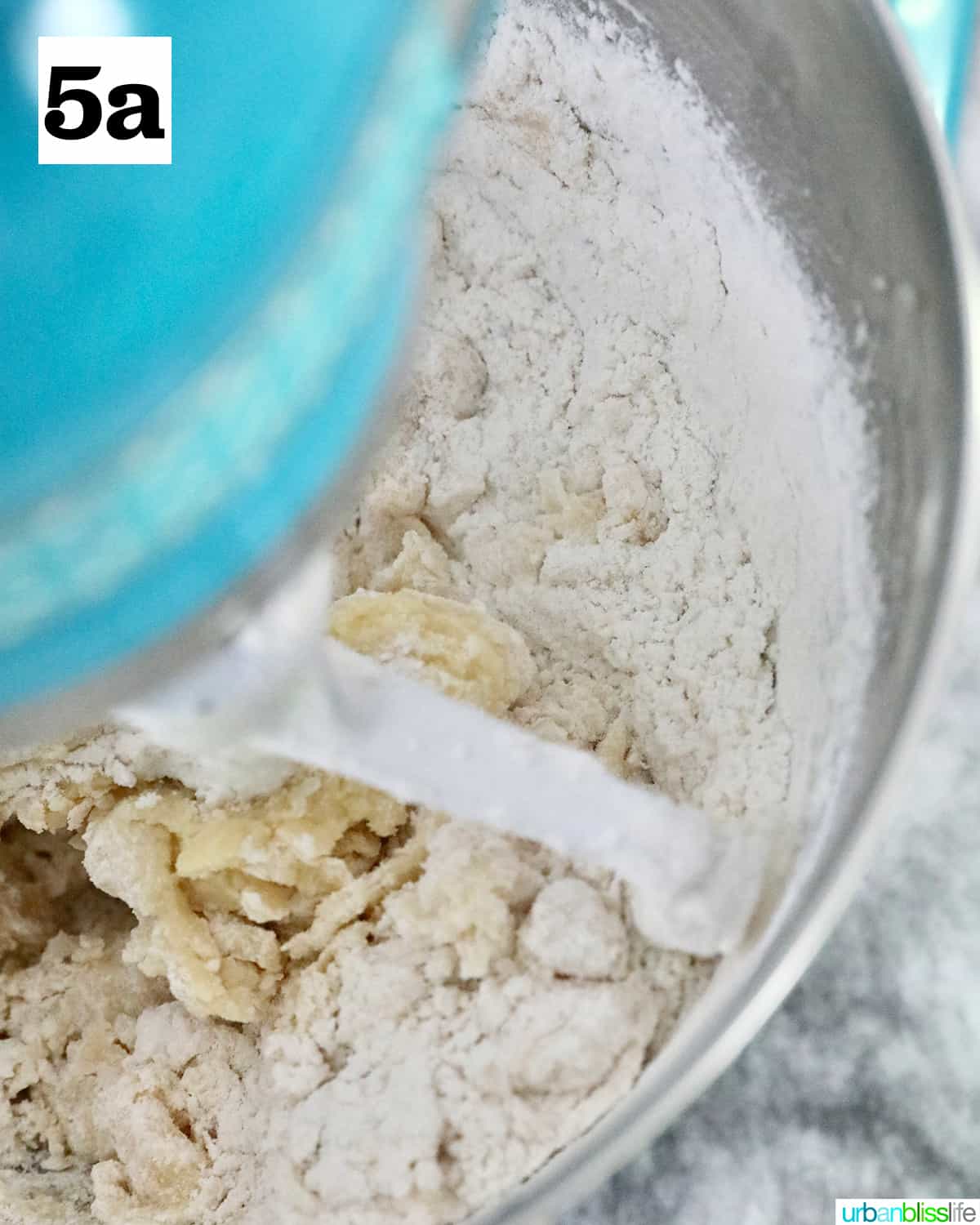 flour mixing in with wet ingredients to make key lime cookies.