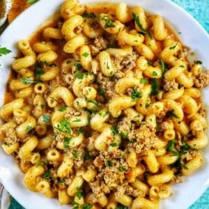 bowl of dairy free one pot cheeseburger pasta with ground turkey and chopped parsley.