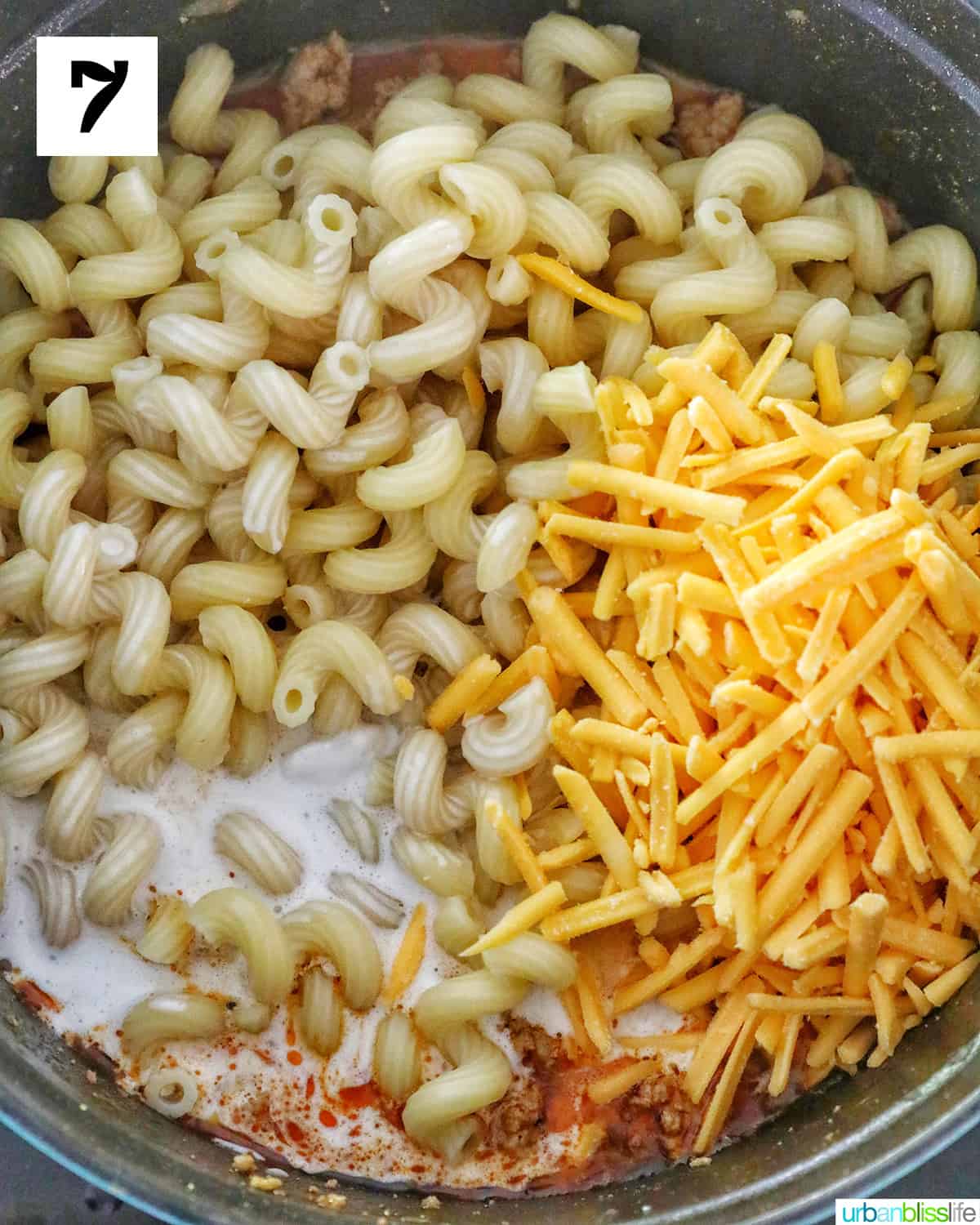 adding dairy free cheese shreds and dairy free cream to pasta.
