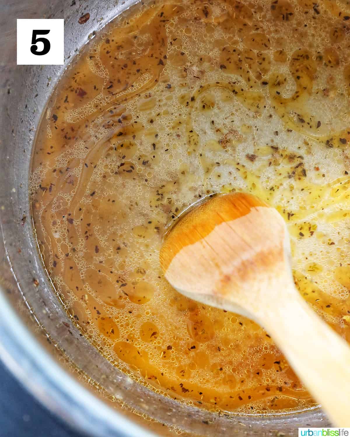 a wooden spoon and added water to deglaze the inside of the Instant Pot pressure cooker