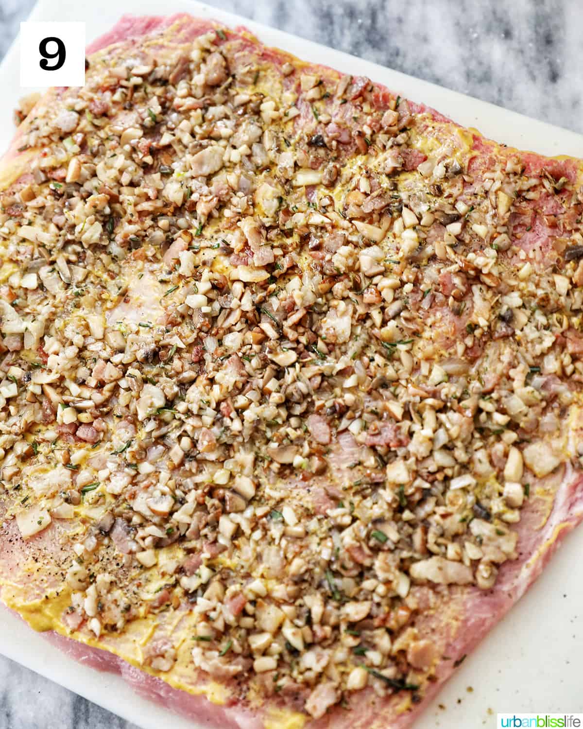 spread mushroom herb mixture evenly over the mustard-topped pork loin.