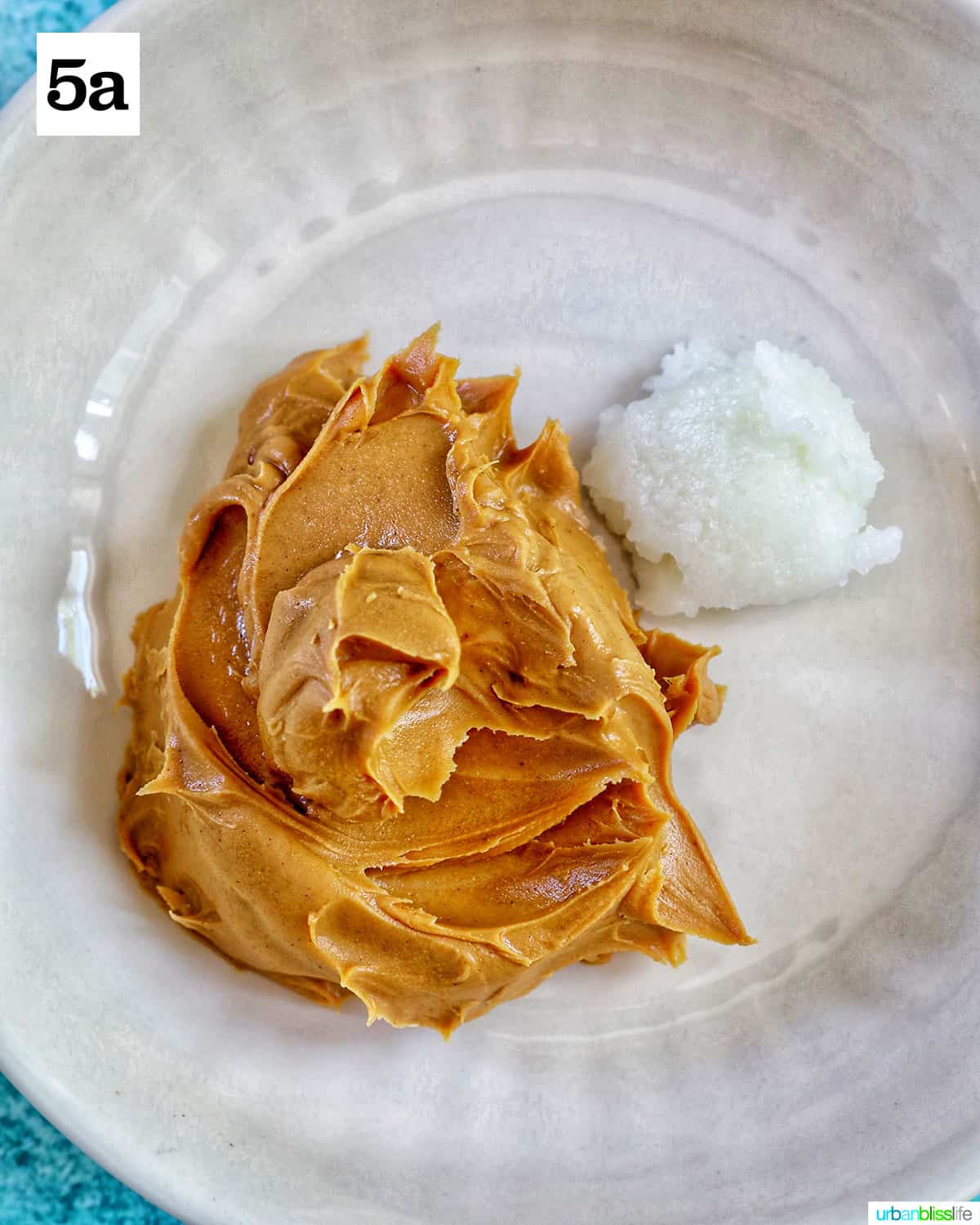 white bowl with peanut butter and coconut oil.